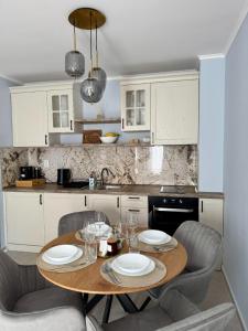 a kitchen with a wooden table with two plates on it at Apartment Summer Vibes in Sveti Vlas