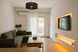 a living room with a couch and a table at 3C Luxury Apartment in Alexandroupoli