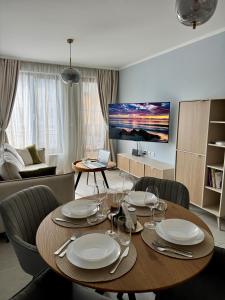 a living room with a dining room table with chairs at Apartment Summer Vibes in Sveti Vlas