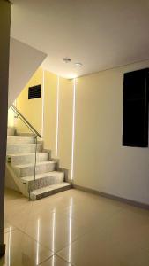 an empty room with stairs and a painting on the wall at Hotel Jelt Aeropuerto in Bogotá +18 photos