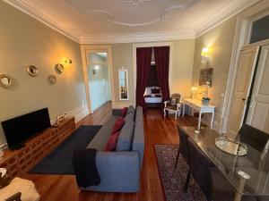 un soggiorno con un divano blu e una televisione di ML Apartments Story a Porto