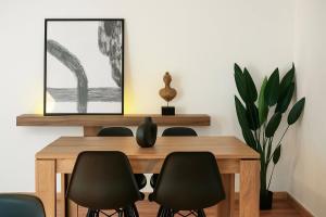 a dining room with a wooden table and chairs at 3C Luxury Apartment in Alexandroupoli