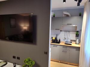 a kitchen with white cabinets and a counter top at Kosmonaudi Apartment - Near Border - Self Chek-In in Narva