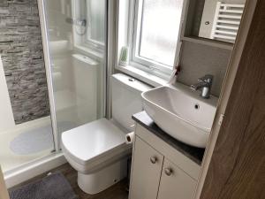 une salle de bain avec toilettes, lavabo et douche dans l'établissement Tattershall Lakes Jet Ski Lake 3 Bedroom Cabin with Private jet ski dock, à Tattershall 11 autres photos