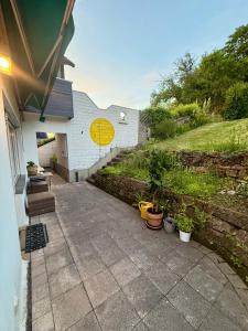 a patio with potted plants next to a house at Gartenstübche in Siegen +24 photos