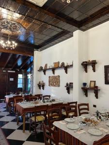 a dining room with wooden tables and chairs at Hotel Kaceli in Berat