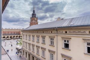 a building with a clock tower in a city at Hotel Experior Boutique - Destigo Hotels in Krakow