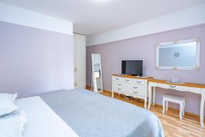 Televízia a/alebo spoločenská miestnosť v ubytovaní Apartments Talija Podgora