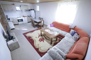 a living room with a couch and a table at Čemerno Mountain House in Gacko