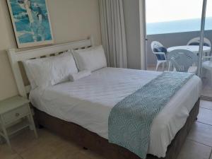 Ένα ή περισσότερα κρεβάτια σε δωμάτιο στο Executive Umhlanga apartment