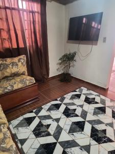 a living room with a black and white checkered floor at Flores da vovó in Campos do Jordão