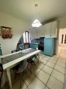 a kitchen with a table and some chairs in it at Blackland- Shabby Tuscany House in Colle Val D'Elsa