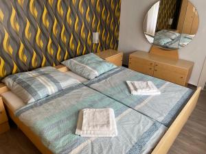 a bedroom with a bed with two towels on it at Ferienhaus Holiday Heaven in Schwarzatal