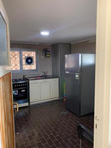 a kitchen with a stainless steel refrigerator and a stove at الزمالك in Cairo +4 photos