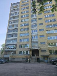 a tall building with a staircase in front of it at Apartaments Kaunas in Kaunas