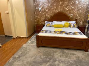 a bedroom with a large bed with yellow pillows at Kericho Finest Home in Kericho