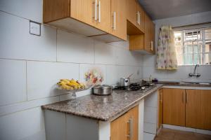 a kitchen with a bowl of fruit on the counter at Kericho Finest Home in Kericho