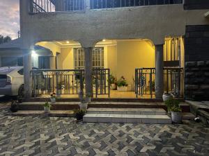 a house with a gate and stairs in front at Kericho Finest Home in Kericho
