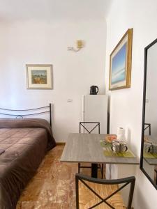 a room with a bed and a table and a bed at Il Nido Al Mare ROOM by 5TR Apartments in Levanto