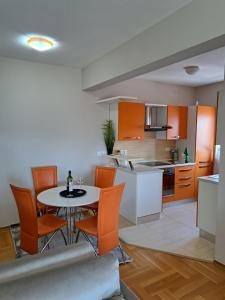 a kitchen and dining room with a table and chairs at Stan u centru BEST VIEW in Bar