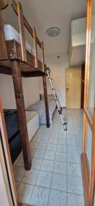 a room with a bunk bed with a ladder in it at Pomposa 41 in Lido di Pomposa