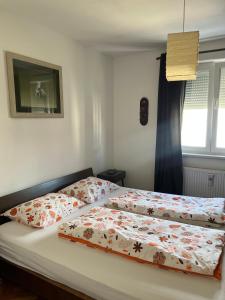 a bed with two pillows on it in a bedroom at Apartment Sunny day in Livno
