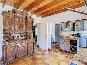 a kitchen with a large wooden cabinet in a room at Ty Lora - Isolée en bord de mer in Telgruc-sur-Mer