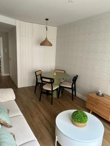 a living room with a table and chairs and a couch at Dania Home Noia in Noya