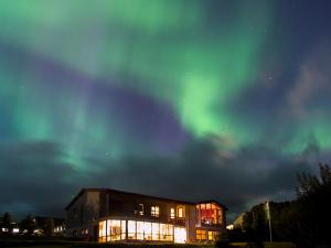 an office building with the aurora in the sky at Stóra-Mörk Guesthouse in Stora Mork