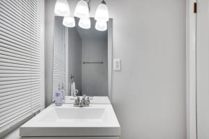 a bathroom with a white sink and a mirror at Close to Hospitals with W&D Priv Parking Fast Wifi in Wilkes-Barre