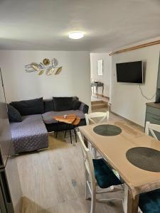 a living room with a couch and a table at Apartment JB2 Grmovine in Risika