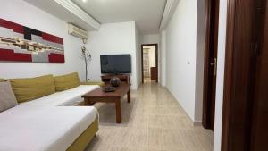 a living room with a couch and a tv at CASA ENTERA PLAYA PUERTO del ROSARIO in Puerto del Rosario
