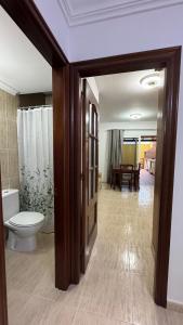 a bathroom with a toilet and a dining room at CASA ENTERA PLAYA PUERTO del ROSARIO in Puerto del Rosario +21 photos