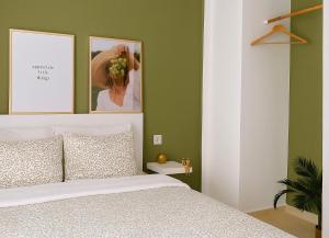 a bedroom with a bed and two pictures on the wall at 3C Luxury Apartment in Alexandroupoli +18 photos
