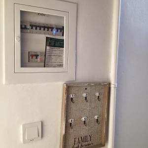 a refrigerator with a picture on the wall at Studio Relax Vacances Loutraki in Loutraki