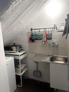 a small kitchen with a sink and a counter at Studio Relax Vacances Loutraki in Loutraki