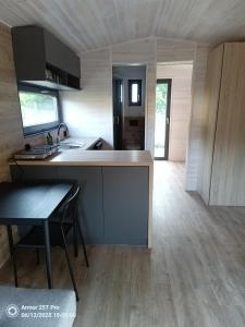 a kitchen with a sink and a counter in a room at Domek letniskowy Osieki Parkowa in Osieki
