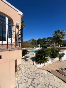 a house with a balcony and a swimming pool at Casa del Rebaldi in Jávea