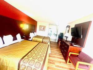a hotel room with two beds and a television at Surry Inn - Dobson - I-77 - Exit 93 in Dobson