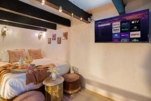 a bedroom with a bed and a tv on the wall at The Dream of Old San Juan by PH in San Juan