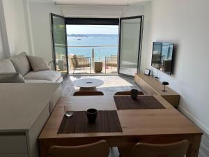 a living room with a table and a view of the ocean at Piso Sinas con vistas al mar in Villanueva de Arosa