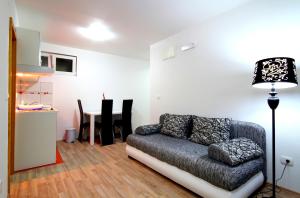 a living room with a couch and a table at Apartments Đurašević in Sveti Stefan
