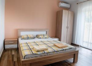 a bedroom with a bed with two pillows on it at Vržina Farm House Skadar Lake in Virpazar