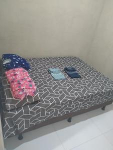 a bed with two pillows on top of it at Vista do vale in Triunfo