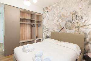 a bedroom with a bed with white towels on it at Maison Rasella Palace Suites in Rome