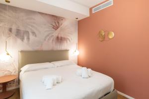 a bedroom with a bed with towels on it at Maison Rasella Palace Suites in Rome