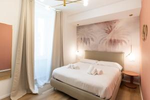 a bedroom with a bed with two towels on it at Maison Rasella Palace Suites in Rome