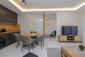 a kitchen and dining room with a table and chairs at B1 first line apartments in Šušanj