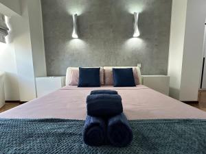 a bedroom with a bed with a blanket on it at Paceville Sandy Beach with Jacuzzi & Free Parking in St Julian's