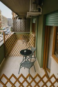 a patio with a table and two chairs on a balcony at 4 Seasons Roma Trastevere in Rome